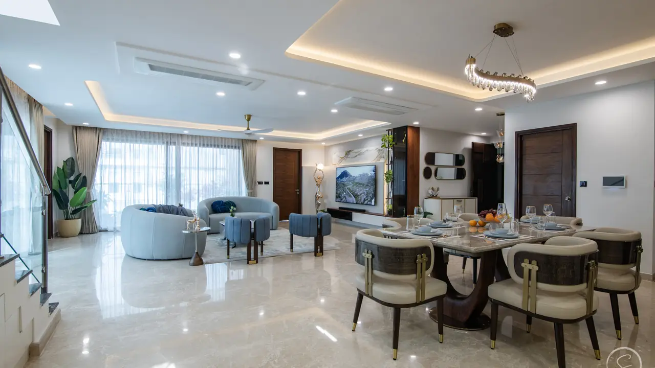 Open living and dining room with a marble floor and a staircase to the upper floor