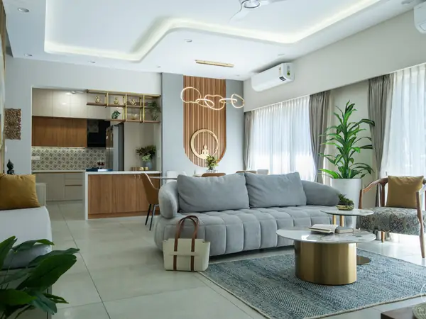 Grey living room opening into a wood-and-white kitchen