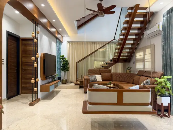 Villa living room with a timber staircase and a swing seat