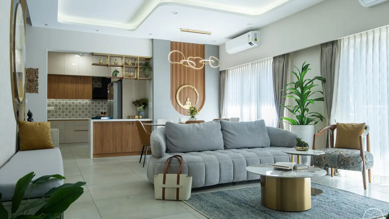 Grey living room opening into a wood-and-white kitchen