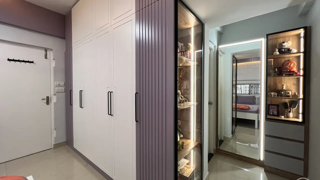 Wardrobe wall beside a lit glass display cabinet