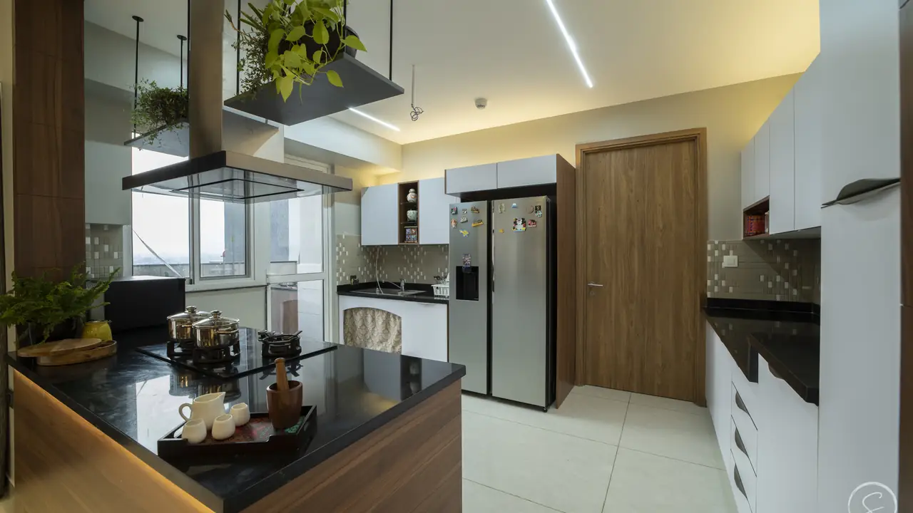 Kitchen island with a black stone top, a hanging plant shelf and white modular cabinets