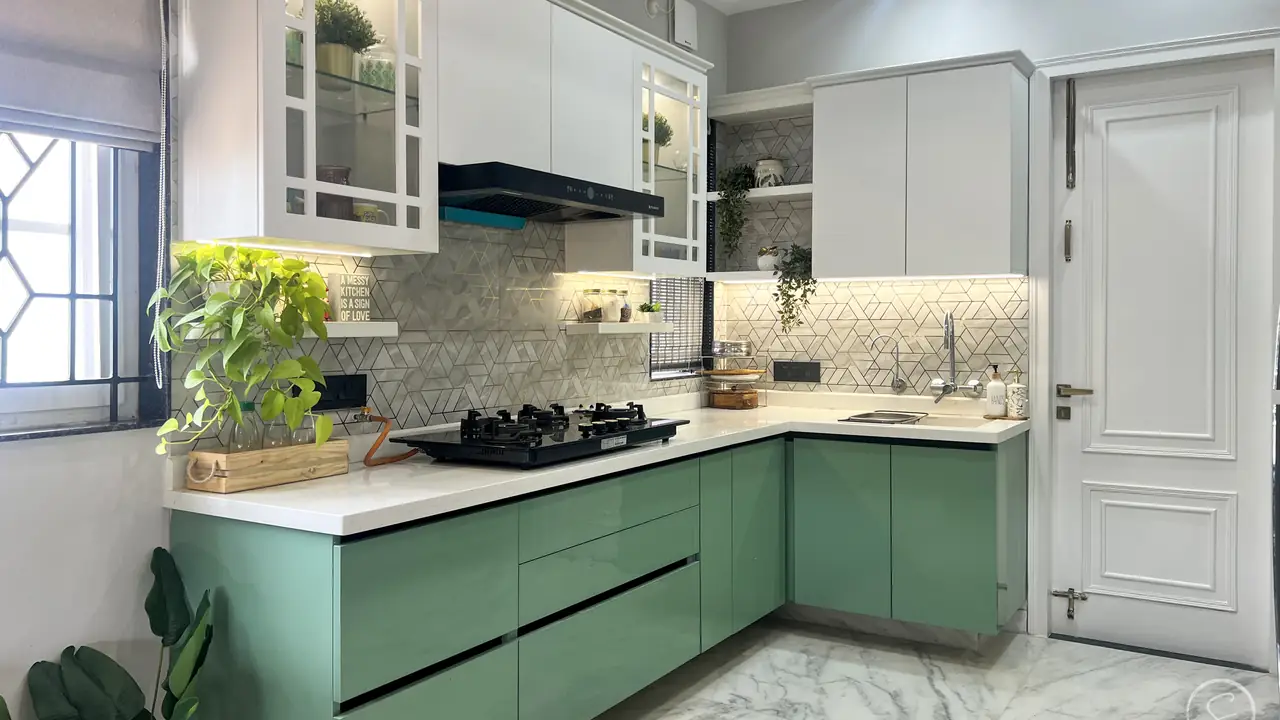 L-shaped kitchen with sage green lower cabinets and white upper units